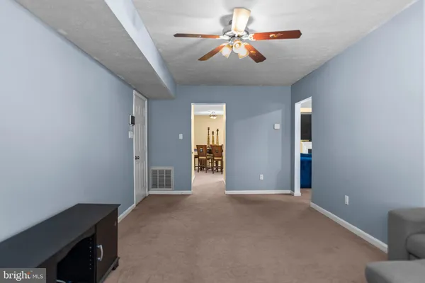 a view of a livingroom with a chandelier fan