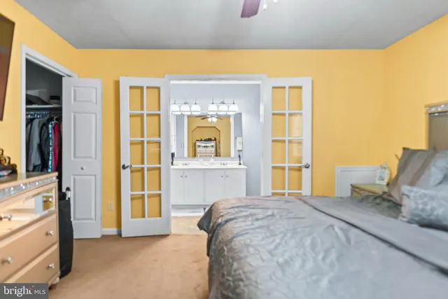 a bedroom with a bed next to a window