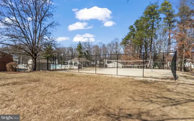 a view of a field with trees in the background