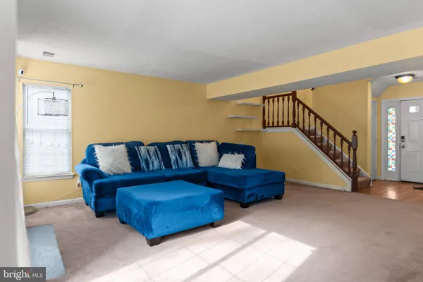 a living room with furniture and stairs
