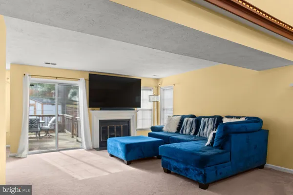 a living room with furniture fireplace and flat screen tv