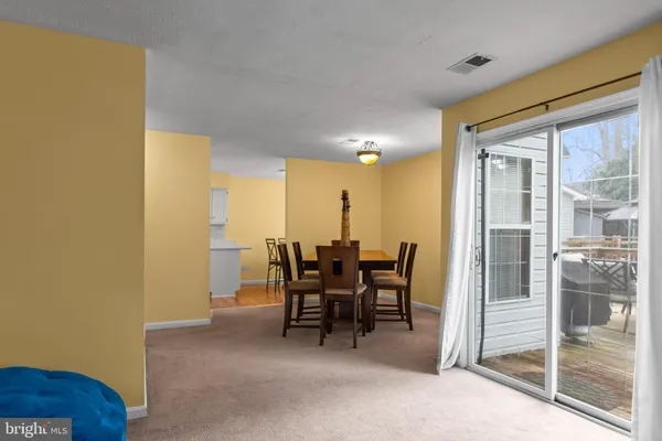 a dining room with furniture and a floor to ceiling window