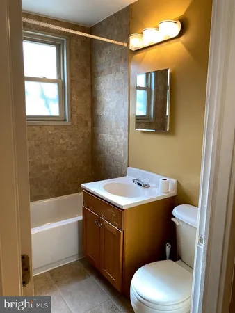 a bathroom with a bathtub and a window