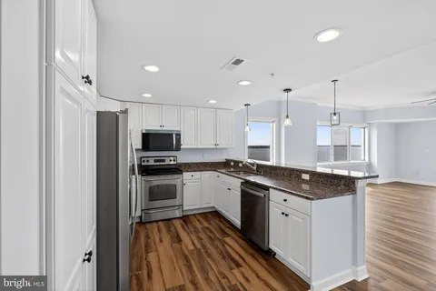 a kitchen with a sink stove and refrigerator
