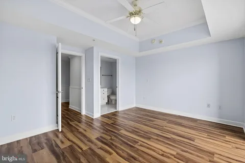 a view of a kitchen with wooden floor and a ceiling fan