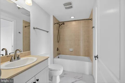 a bathroom with a sink toilet tub and shower