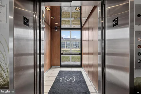 a view of a hallway with wooden floor and entryway