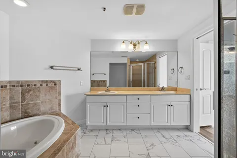 a bathroom with a glass shower door and mirror