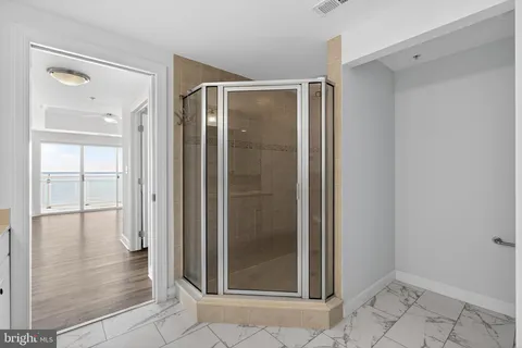 a bathroom with a glass shower door