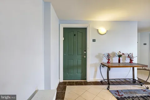 a room with mirror and furniture