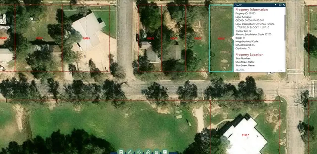 an aerial view of residential houses with outdoor space and trees