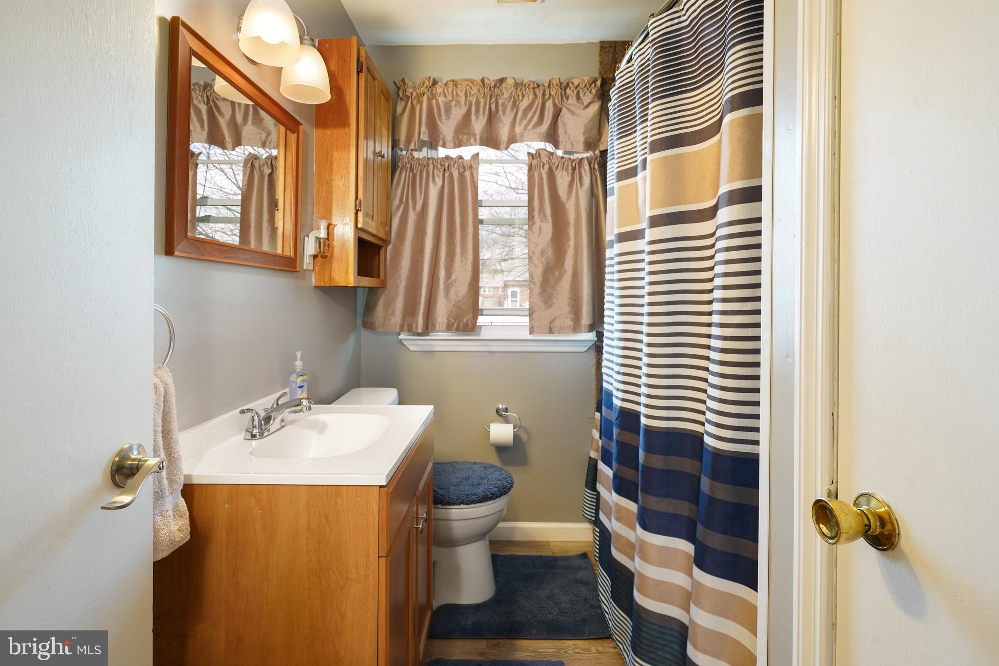 1136 Musket Road Newark, DE 19713 - Photo 13 of 16 a bathroom with a sink and mirror with toilet