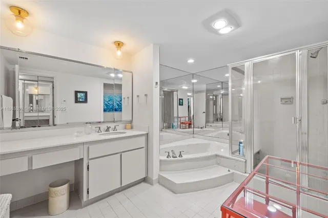a bathroom with a tub sink and mirror