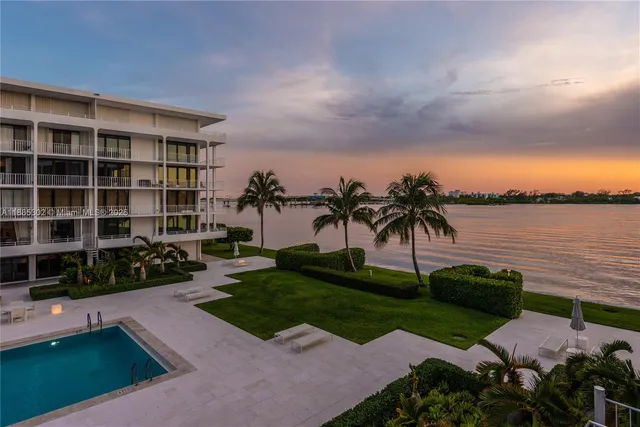 a view of a garden with a bench in front of house