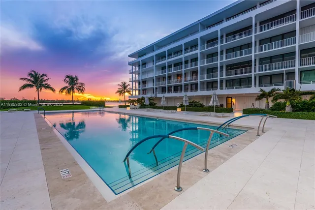 a view of swimming pool with outdoor seating and potted plants