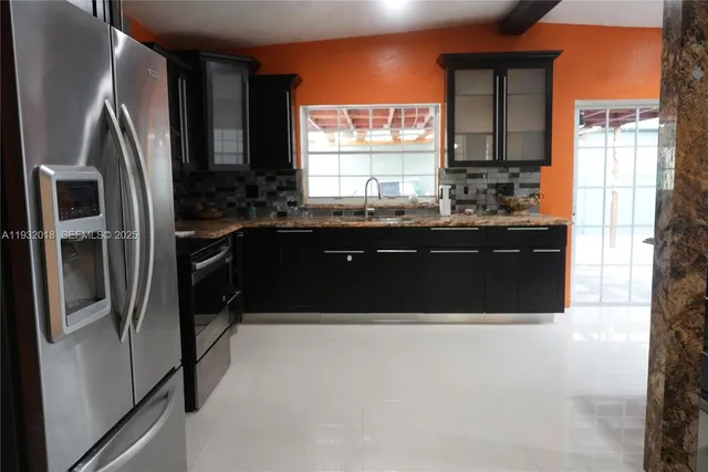 a kitchen with a sink and a refrigerator