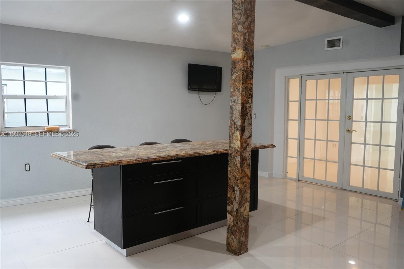 3285 Northwest 97th Street Miami, FL 33147 - Photo 13 of 44 a view of cabinets with wooden floor