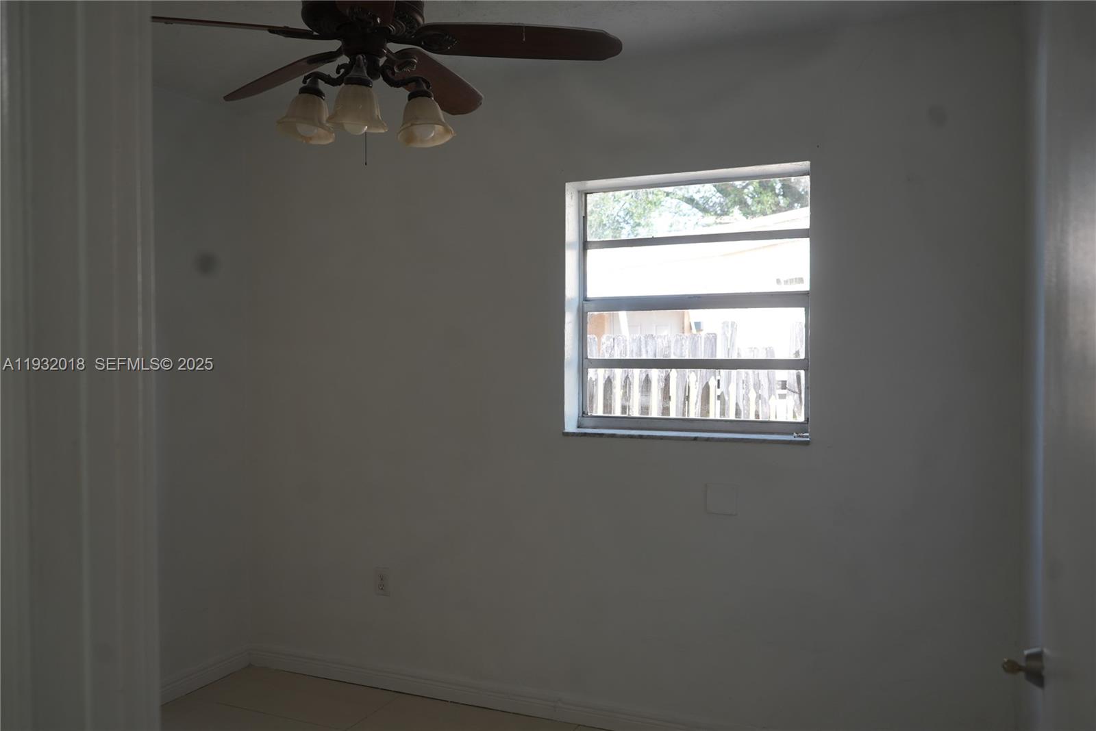 3285 Northwest 97th Street Miami, FL 33147 - Photo 20 of 44 an empty room with a window