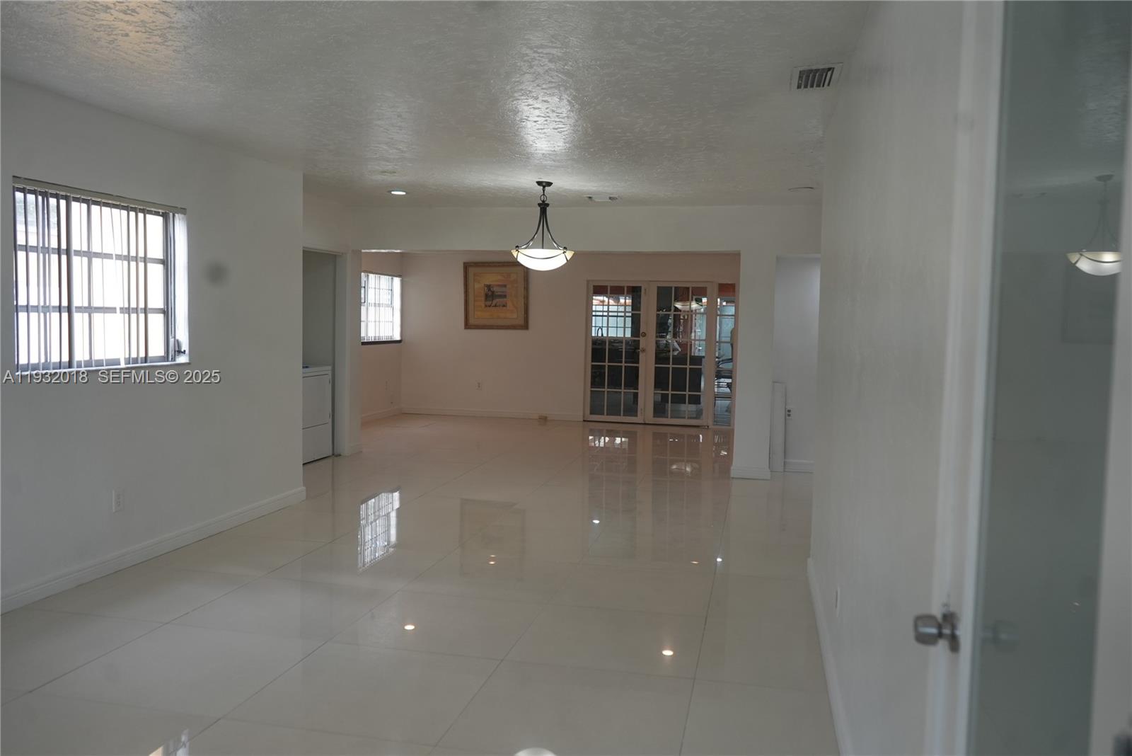 3285 Northwest 97th Street Miami, FL 33147 - Photo 2 of 44 wooden floor in an empty room with a window