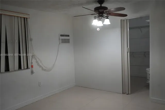 an empty room with a ceiling fan