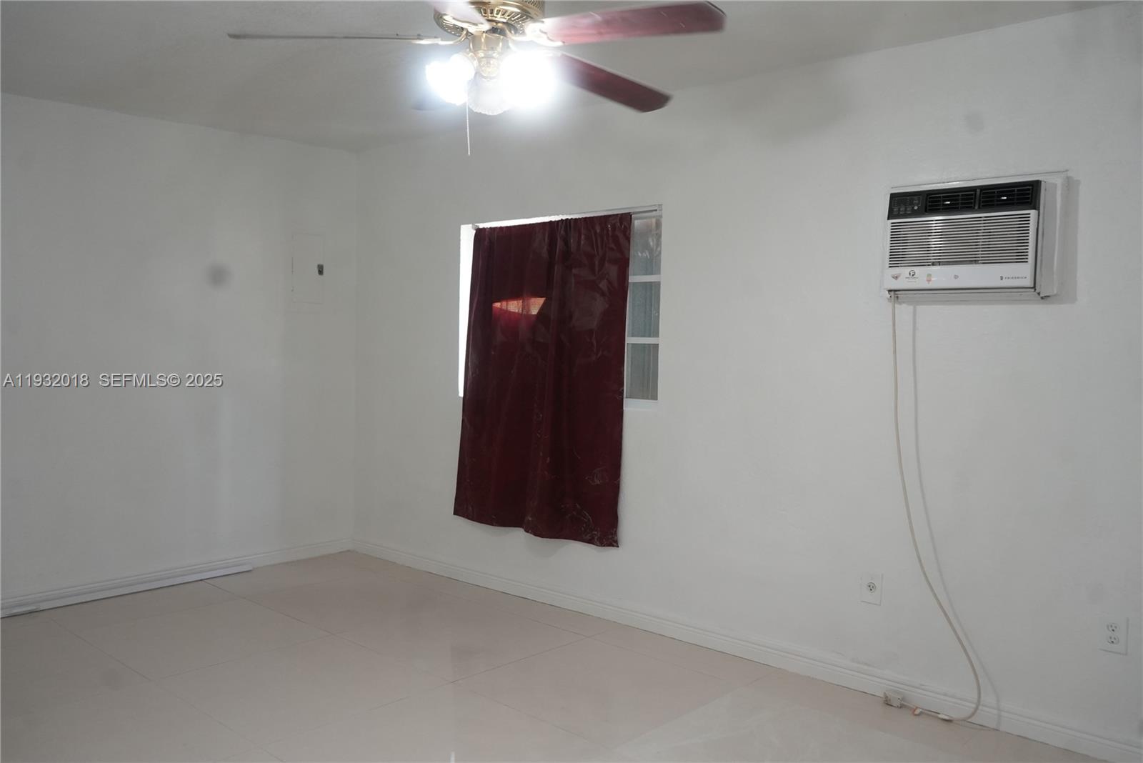 3285 Northwest 97th Street Miami, FL 33147 - Photo 25 of 44 an empty room with a ceiling fan and window