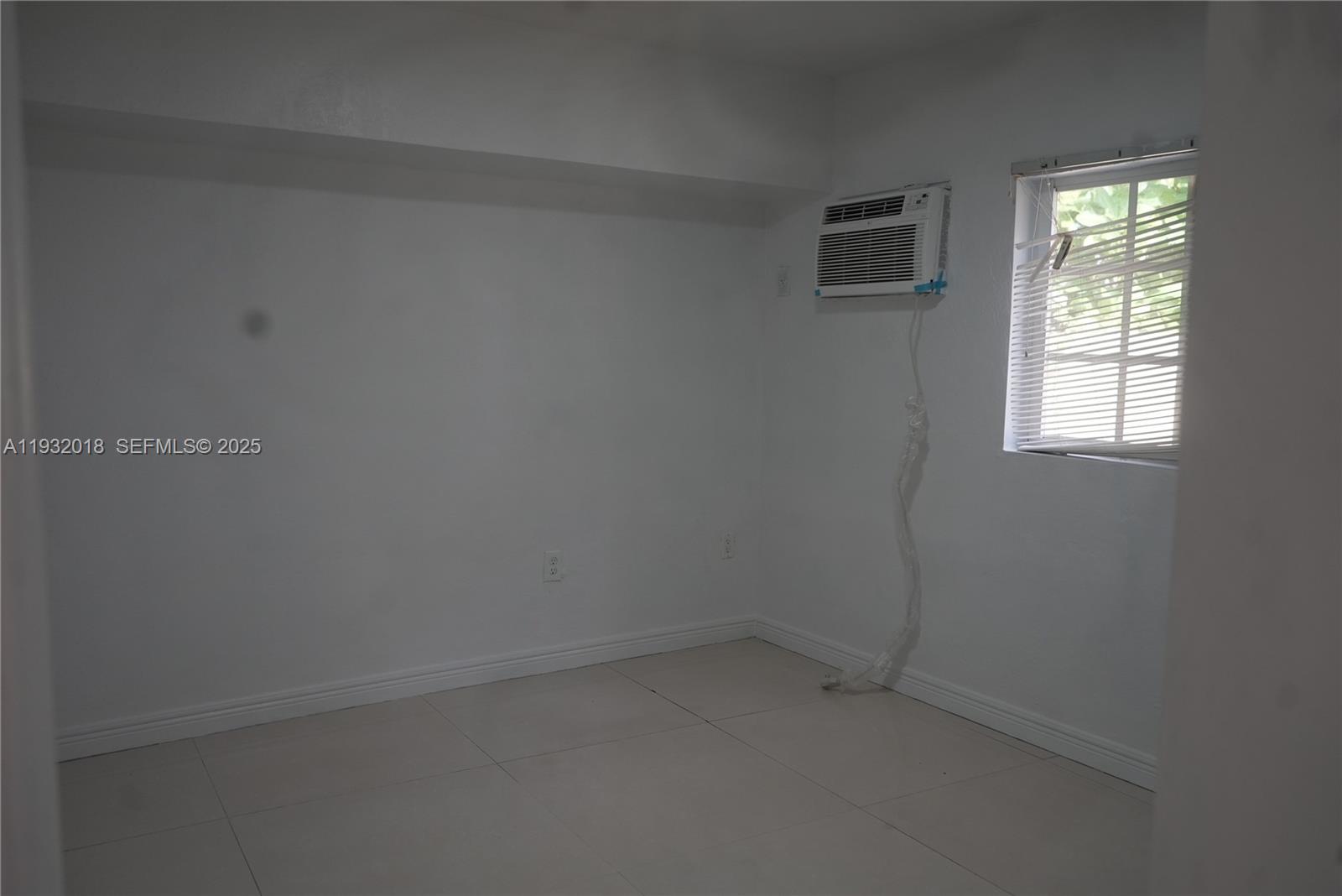 3285 Northwest 97th Street Miami, FL 33147 - Photo 27 of 44 an empty room with a window