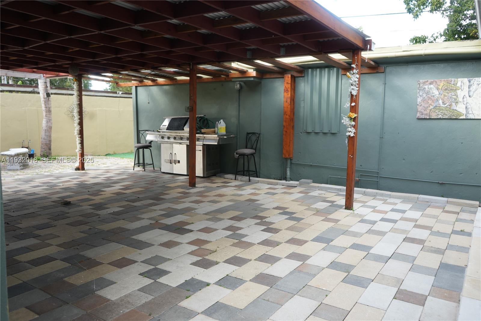 3285 Northwest 97th Street Miami, FL 33147 - Photo 31 of 44 a view of a backyard of a house with table and chairs