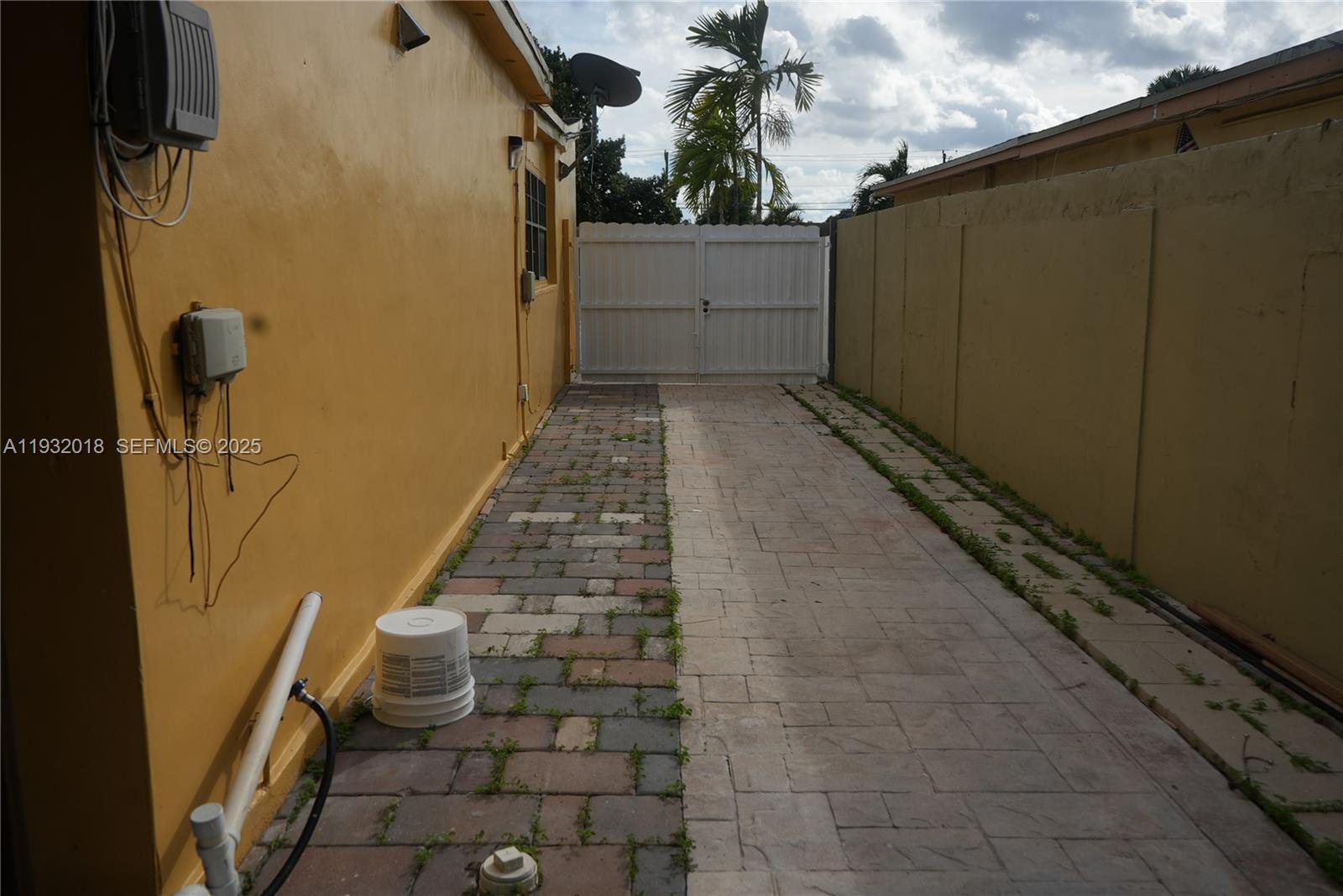 3285 Northwest 97th Street Miami, FL 33147 - Photo 34 of 44 a view of a pathway of a house with wooden fence