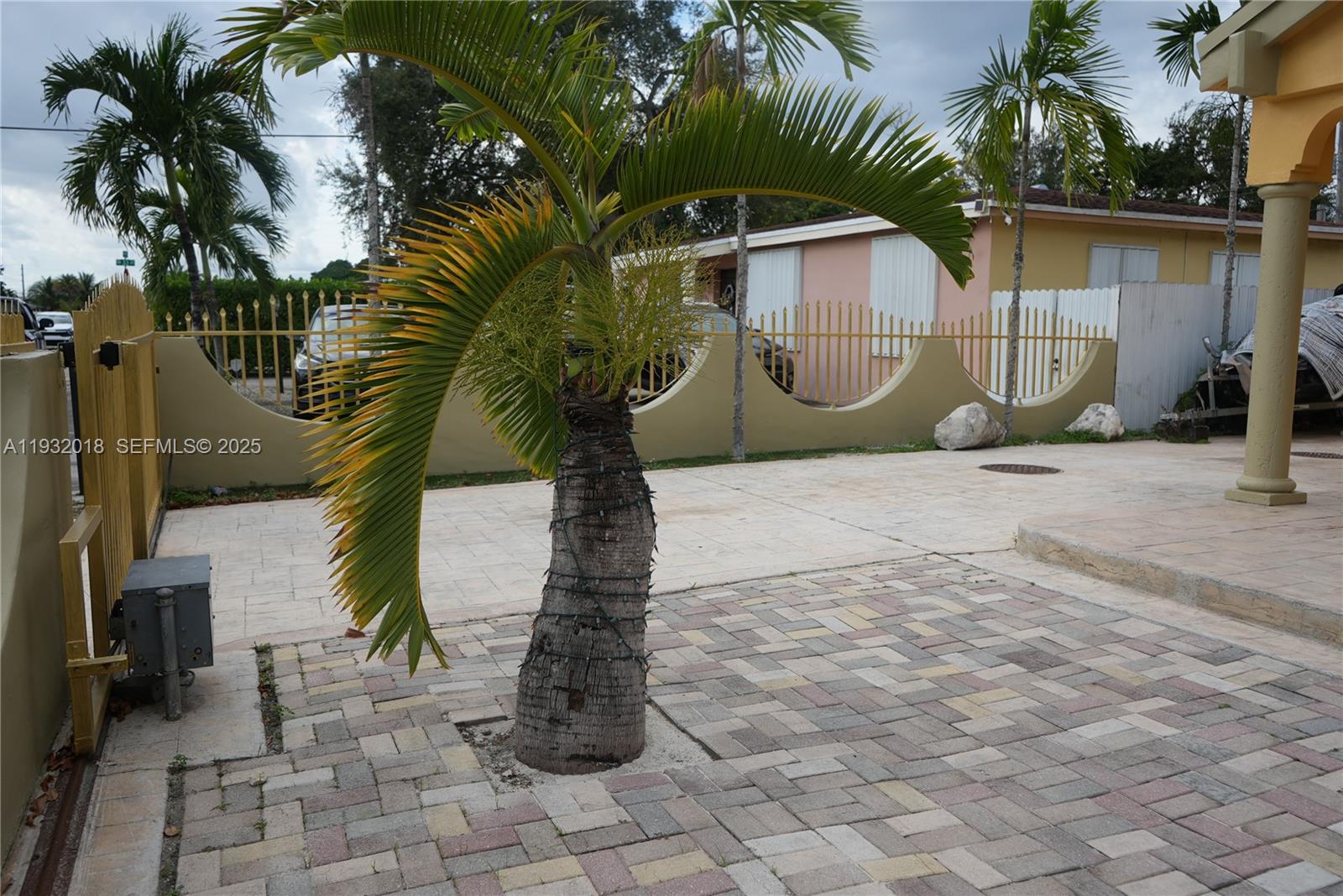 3285 Northwest 97th Street Miami, FL 33147 - Photo 39 of 44 a front view of a house with a yard and palm trees
