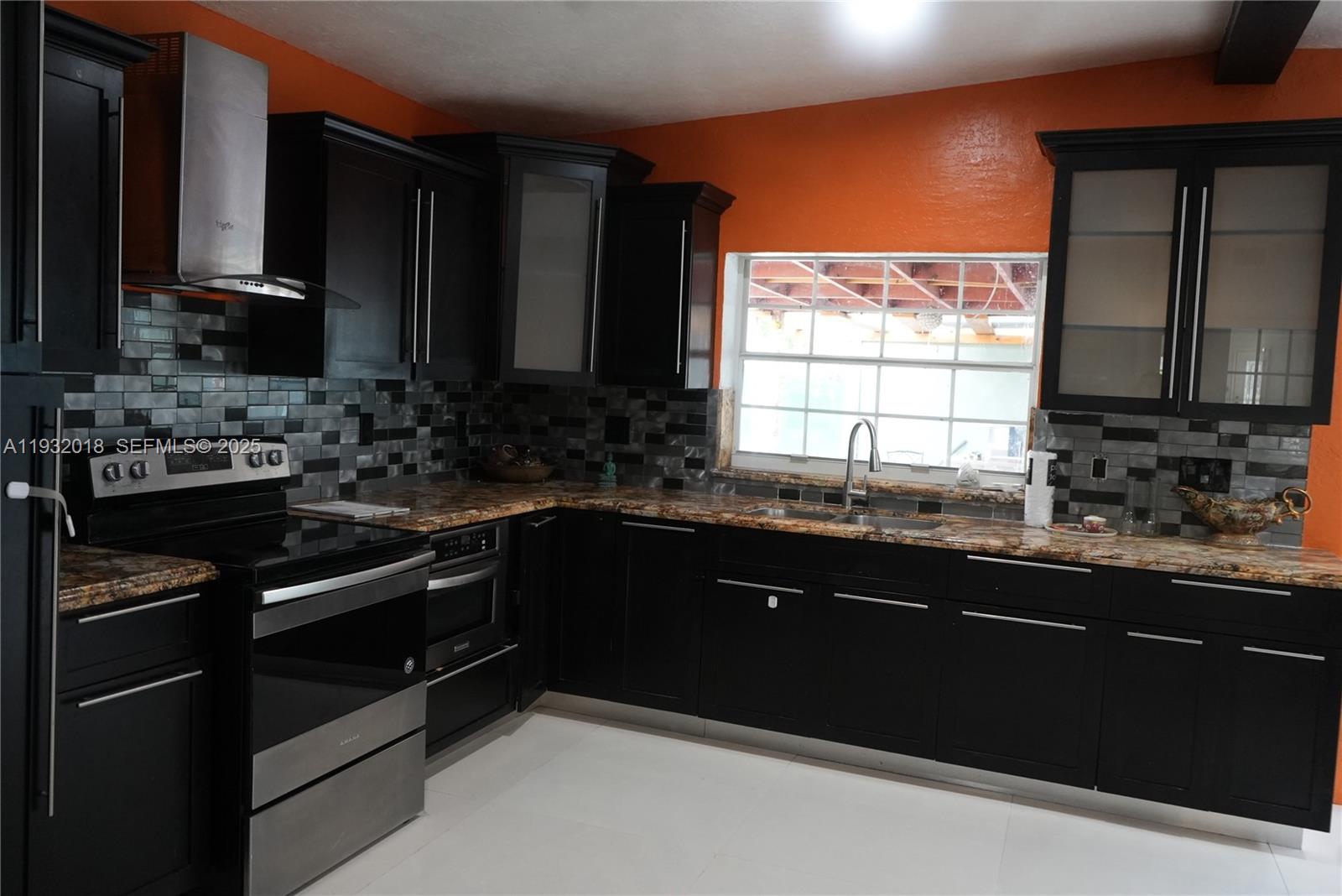 3285 Northwest 97th Street Miami, FL 33147 - Photo 9 of 44 a kitchen with a sink stove and microwave
