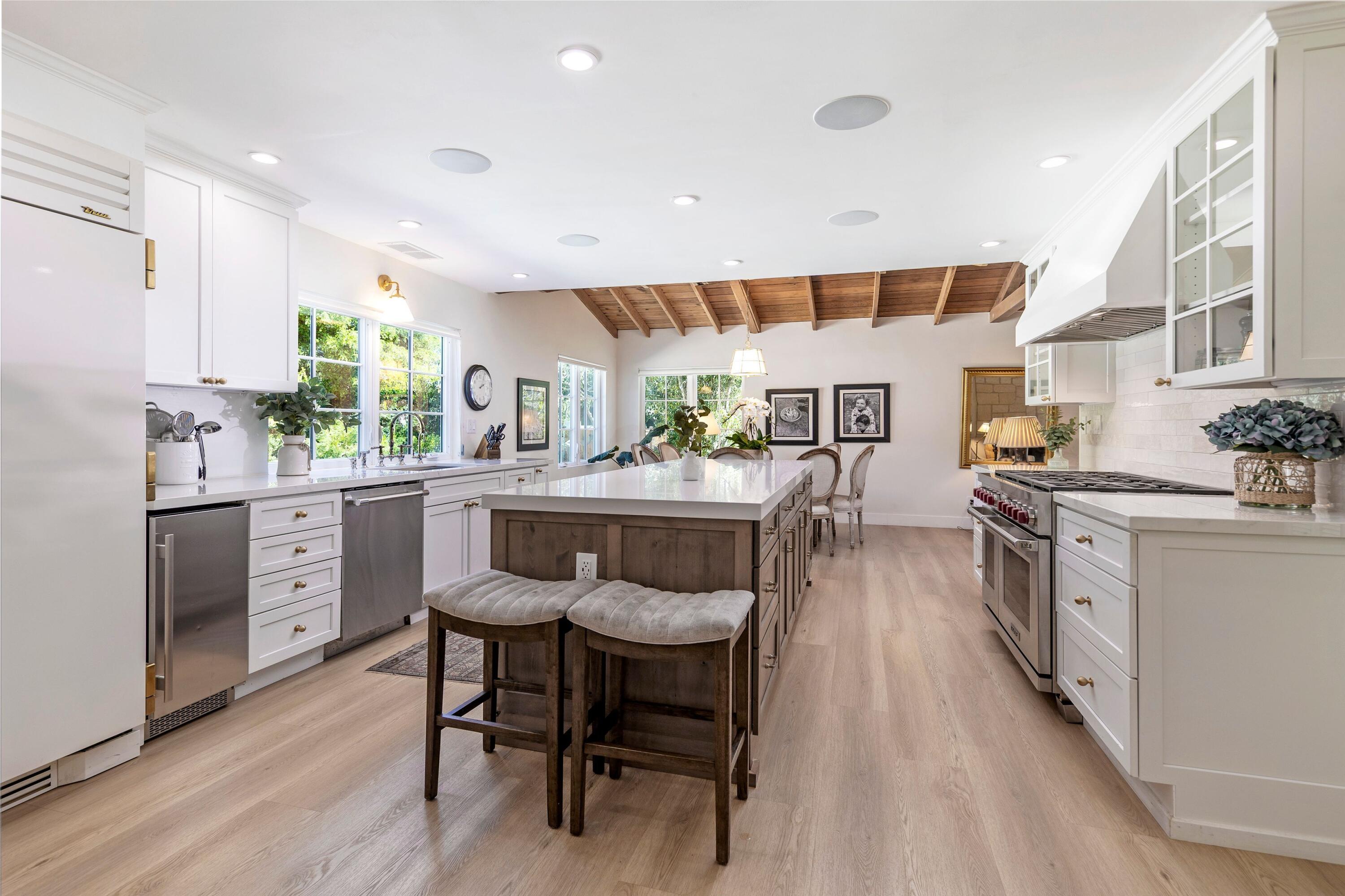 487 Hot Springs Road Santa Barbara, CA 93108 - Photo 6 of 47 a kitchen with a table chairs stove and cabinets