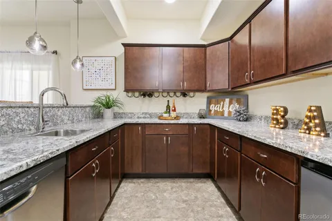 a kitchen with stainless steel appliances granite countertop a sink stove and cabinets