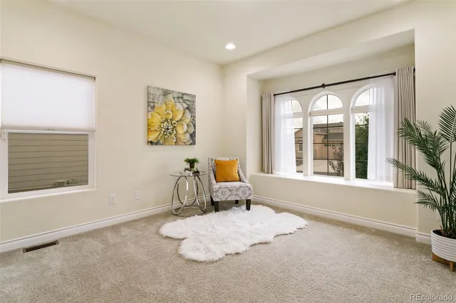 a bathroom with a granite countertop toilet a sink and a mirror