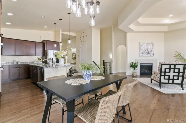 a kitchen with kitchen island granite countertop a table and chairs in it