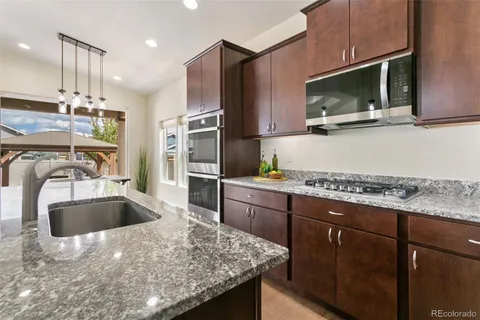 a view of a dining room with furniture and a chandelier