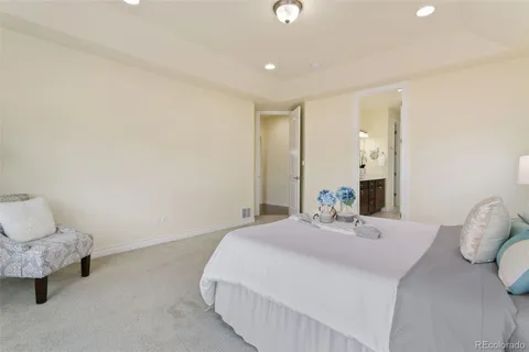 a bedroom with a bed and a lamp