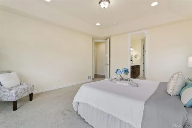 a bedroom with a bed and a lamp