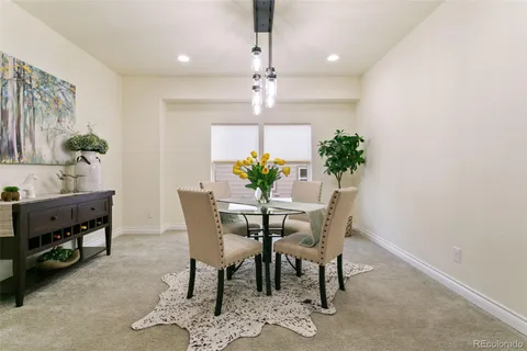 a view of a dining room with furniture and a chandelier