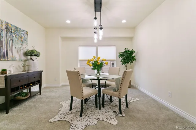 a view of a dining room with furniture and a chandelier