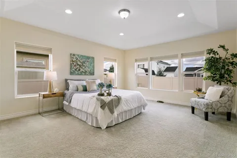 a spacious bedroom with a bed and a window