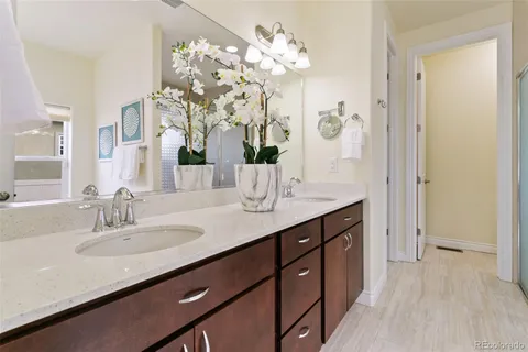 a bathroom with a sink vanity granite and a mirror
