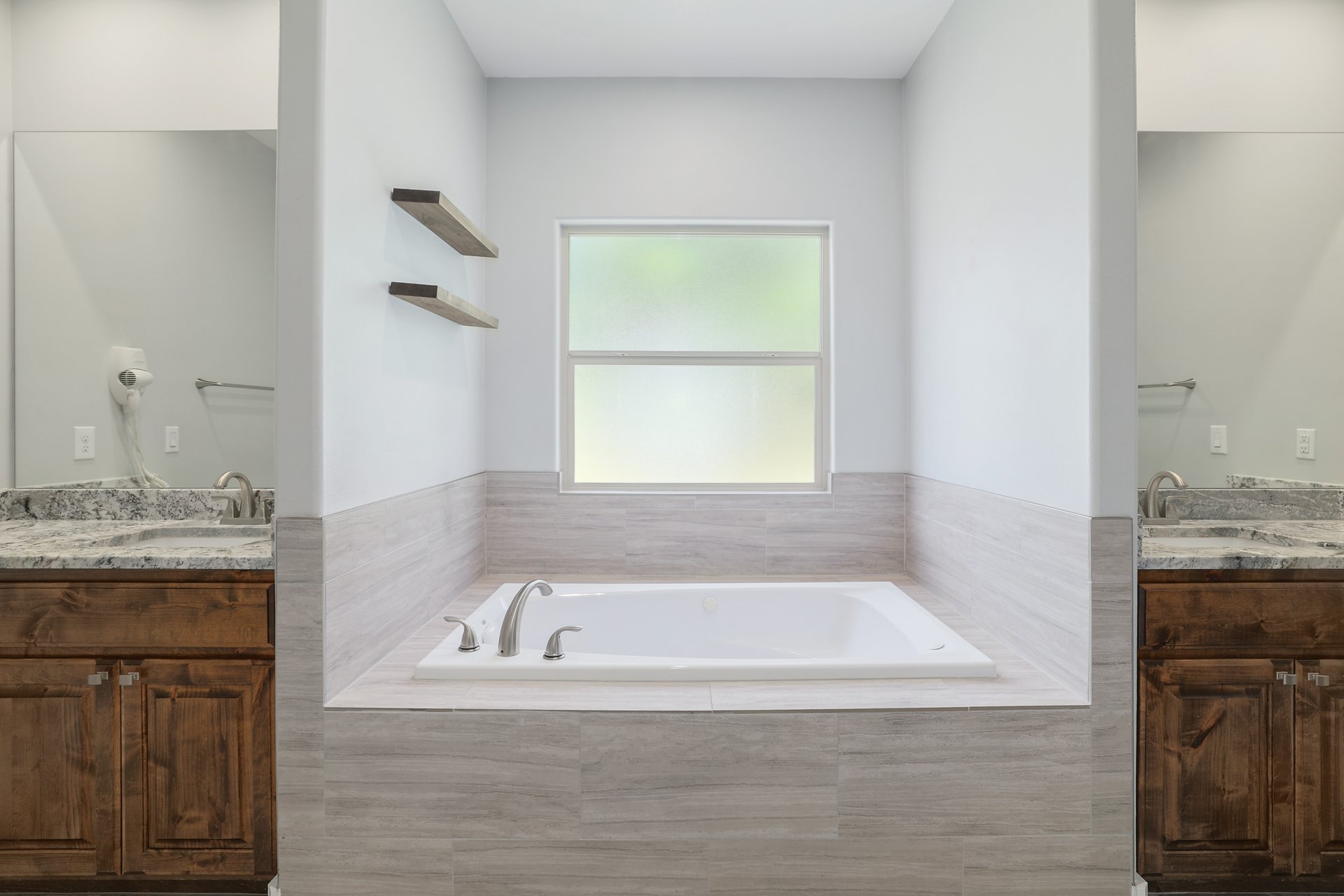 258 County Road Bastrop, TX 78602 - Photo 14 of 32 a bathroom with a granite countertop tub sink and mirror