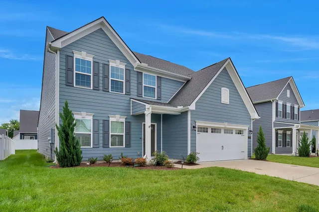 a view of a hallway with wooden floor and entryway