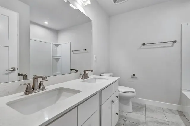 a view of a kitchen with refrigerator and window