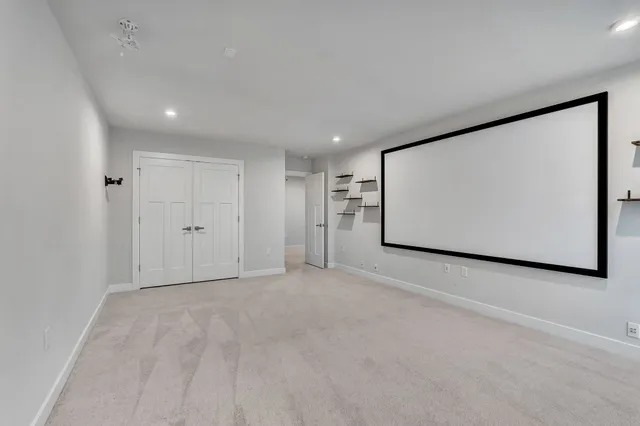 an empty room with a painting on the wall