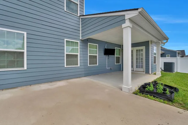 a front view of a house with yard and green space