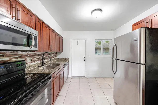 a kitchen with a refrigerator stove and microwave