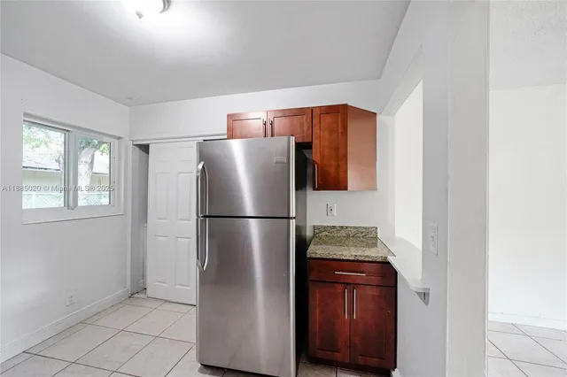 a white refrigerator freezer and a stove sitting inside of a kitchen