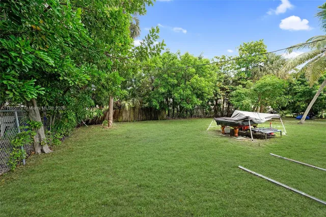 a view of a backyard with sitting area