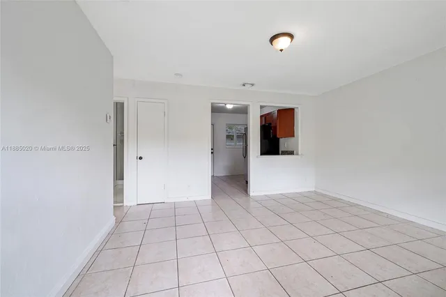 a view of a livingroom with an empty space and a window
